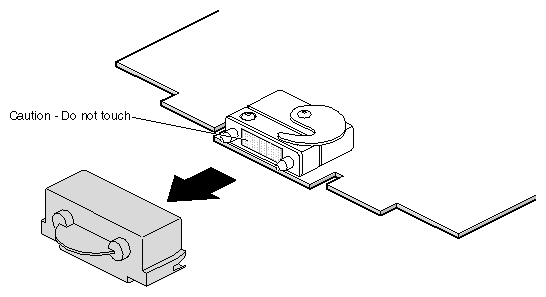 Figure 5-17 Removing the Cap from the XIO Board Compression Connector